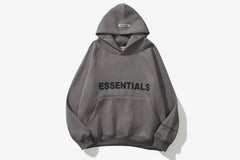 ESSENTIALS Oversized Hoodie in gray, featuring bold black text, spacious hood, and relaxed fit, perfect for casual wear.
