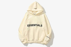 ESSENTIALS Oversized Hoodie in a neutral beige tone, featuring a spacious hood and relaxed fit for comfort and style.