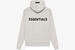 Essentials Core Collection Pullover Hoodie in light gray with black "ESSENTIALS" print on the back.