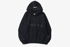 Black ESSENTIALS oversized hoodie with spacious hood and relaxed fit, ideal for casual and athleisure outfits.